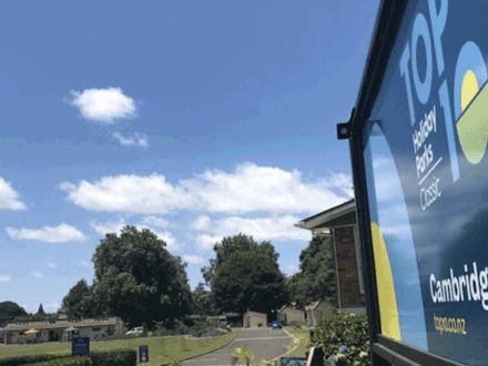 Entrance sign to holiday park with blue sky in background