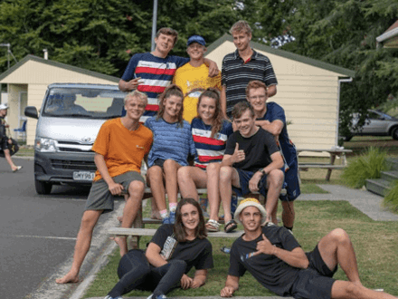Teenagers posing for group photo on picnic table