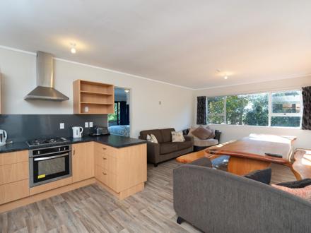 Lodge communal kitchen and living area at Ahipara TOP 10 Holiday Park