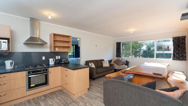 Lodge communal kitchen and living area at Ahipara TOP 10 Holiday Park