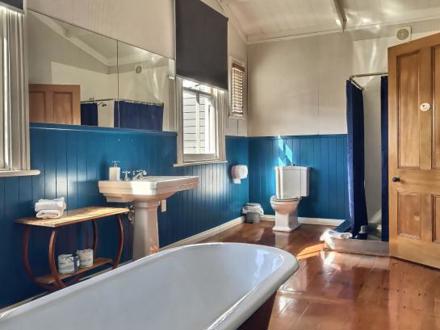 Villa bathroom with antique features and blue panelling