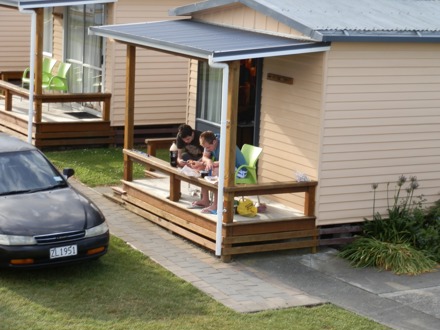 Standard Cabin people relaxing outside  Timaru Top10 Holiday Park