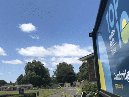 Entrance sign to holiday park with blue sky in background