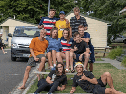 Teenagers posing for group photo on picnic table