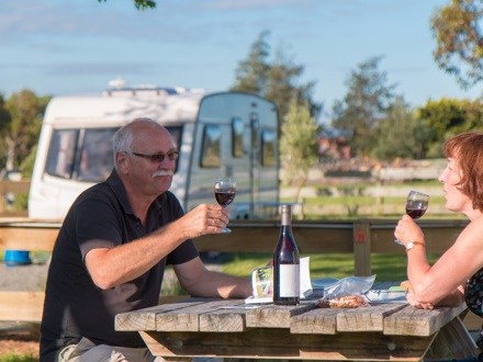 Couple enjoying a glass of wine at Martinborough TOP 10 Holiday Park